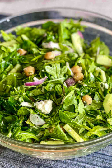 Chickpea Cucumber Salad in a glass bowl on table.