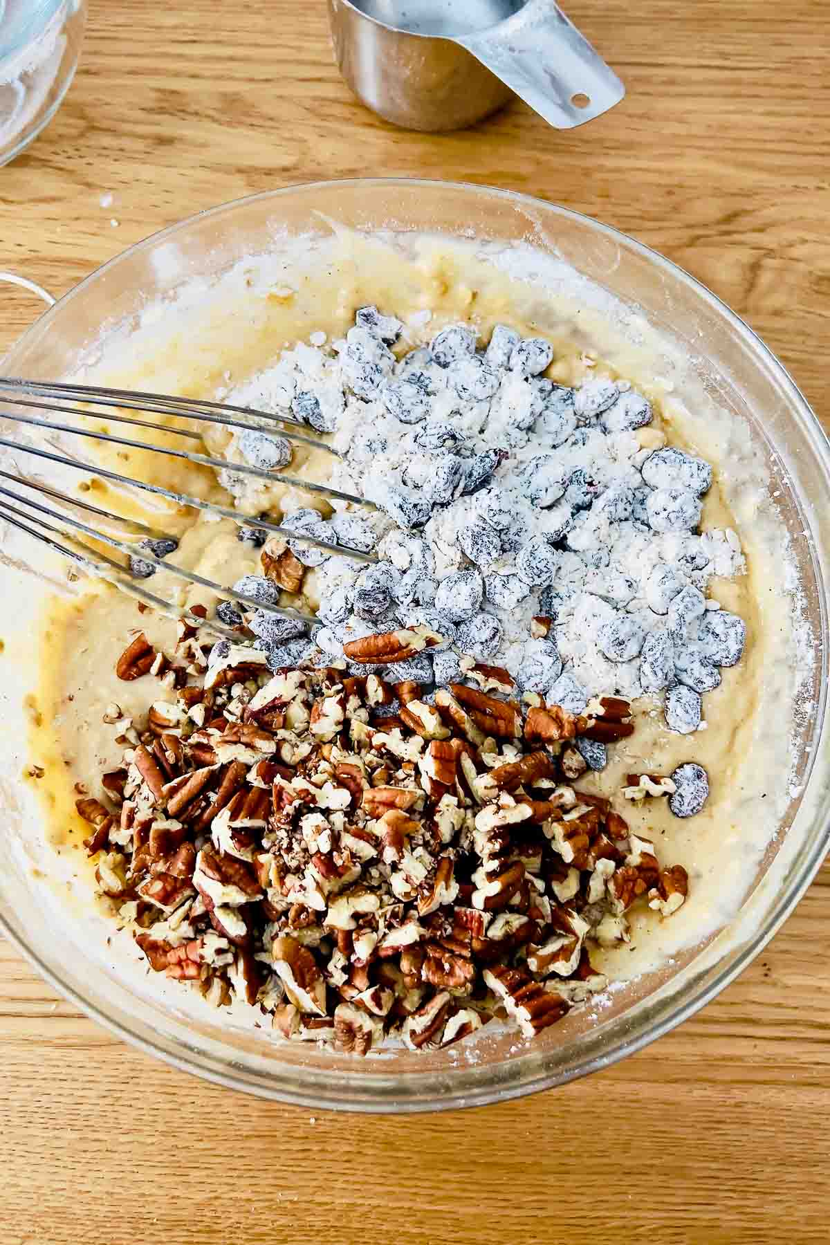 Adding pecans and cranberries to the batter.