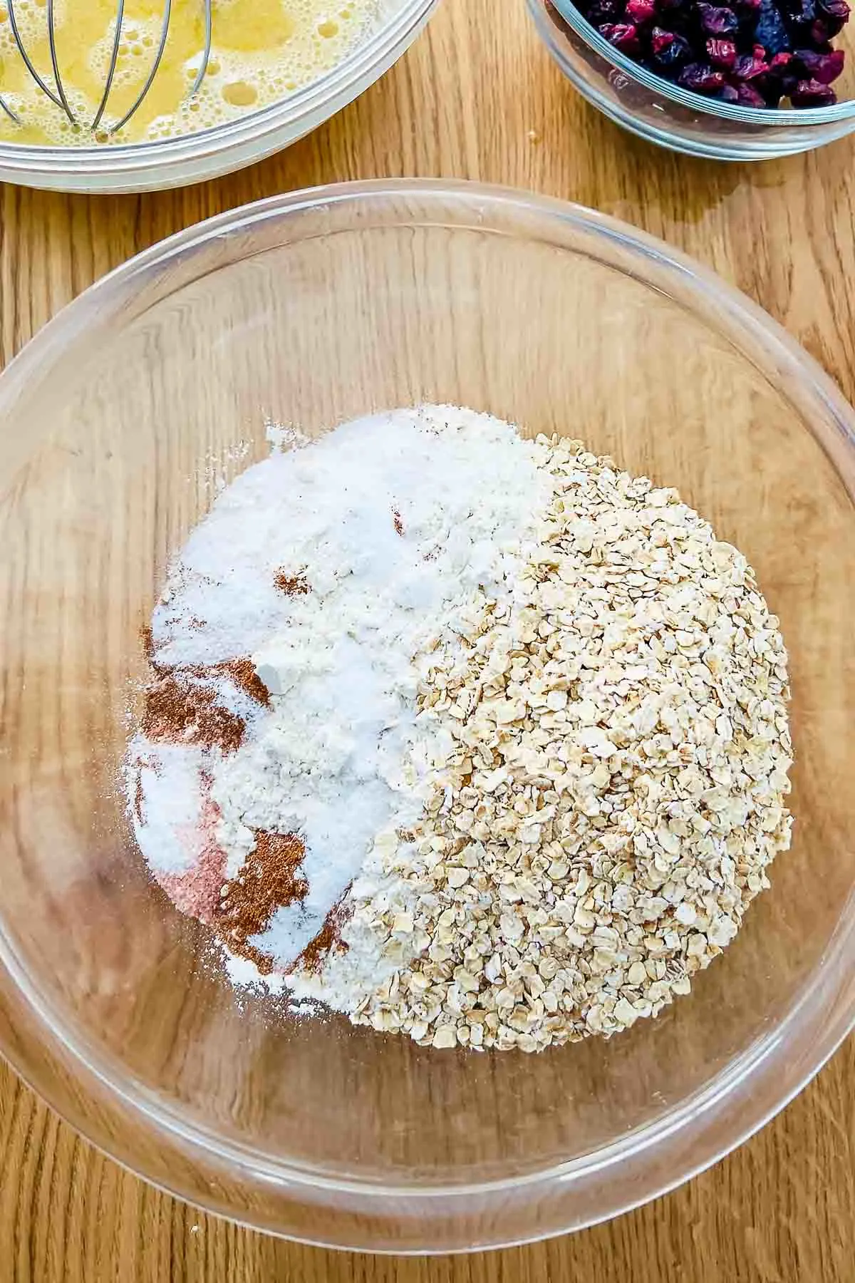 Dry ingredients in a glass bowl for cranberry oatmeal bread.