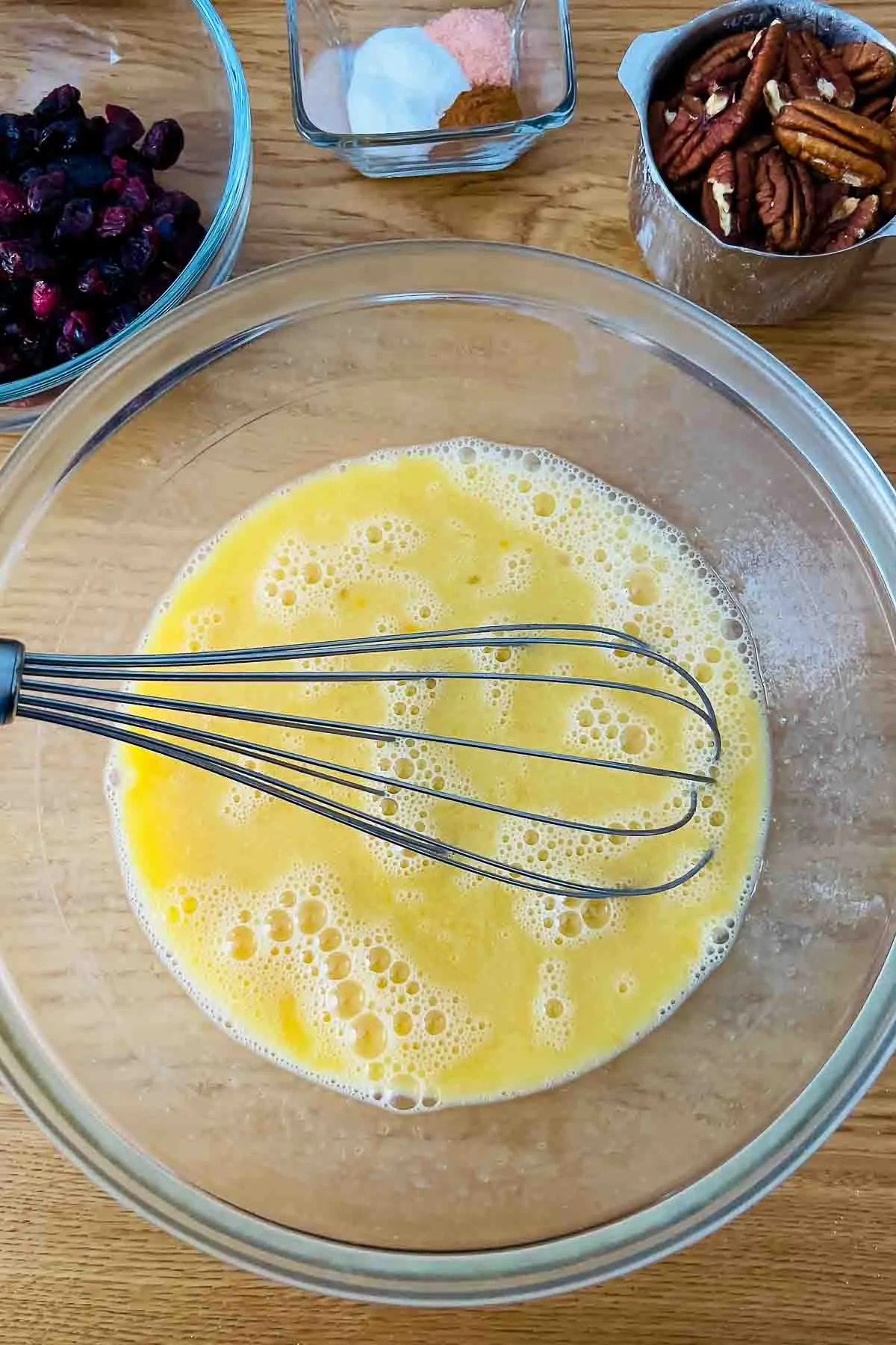 Mixed honey eggs milk and oil in a glass bowl