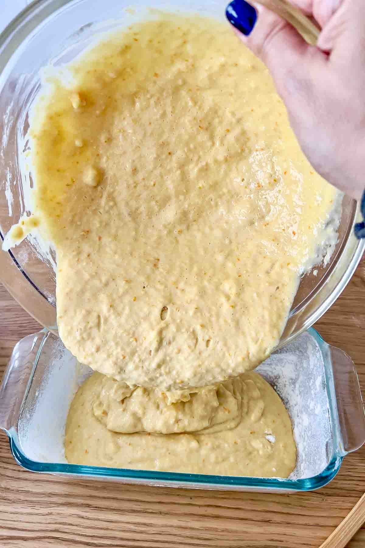 Pouring the batter into a bread loaf pan.