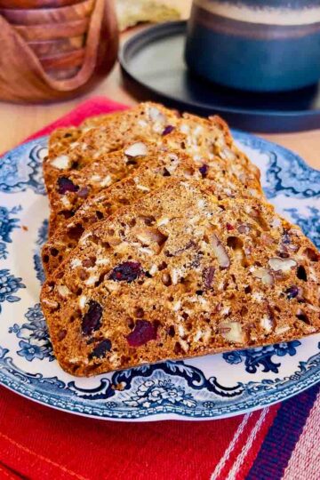 Sliced Cranberry Oatmeal Quick Bread on a blue plate.