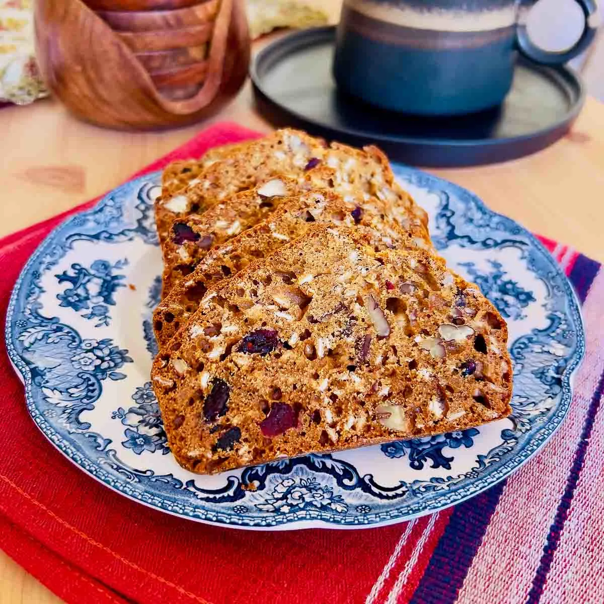 Sliced Cranberry Oatmeal Quick Bread on a blue plate.