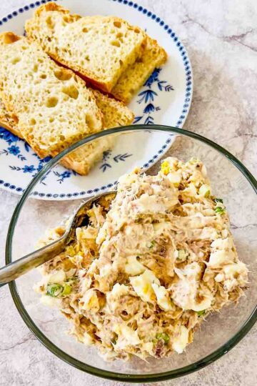 Tuna Egg Salad With Greek Yogurt in a glass bowl served with bread.