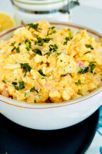 Egg Salad With Cream Cheese in bowl served with bread.