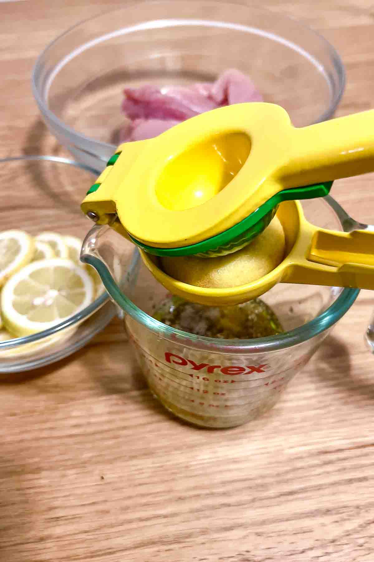 Adding lemon juice to the spices in a measuring cup.