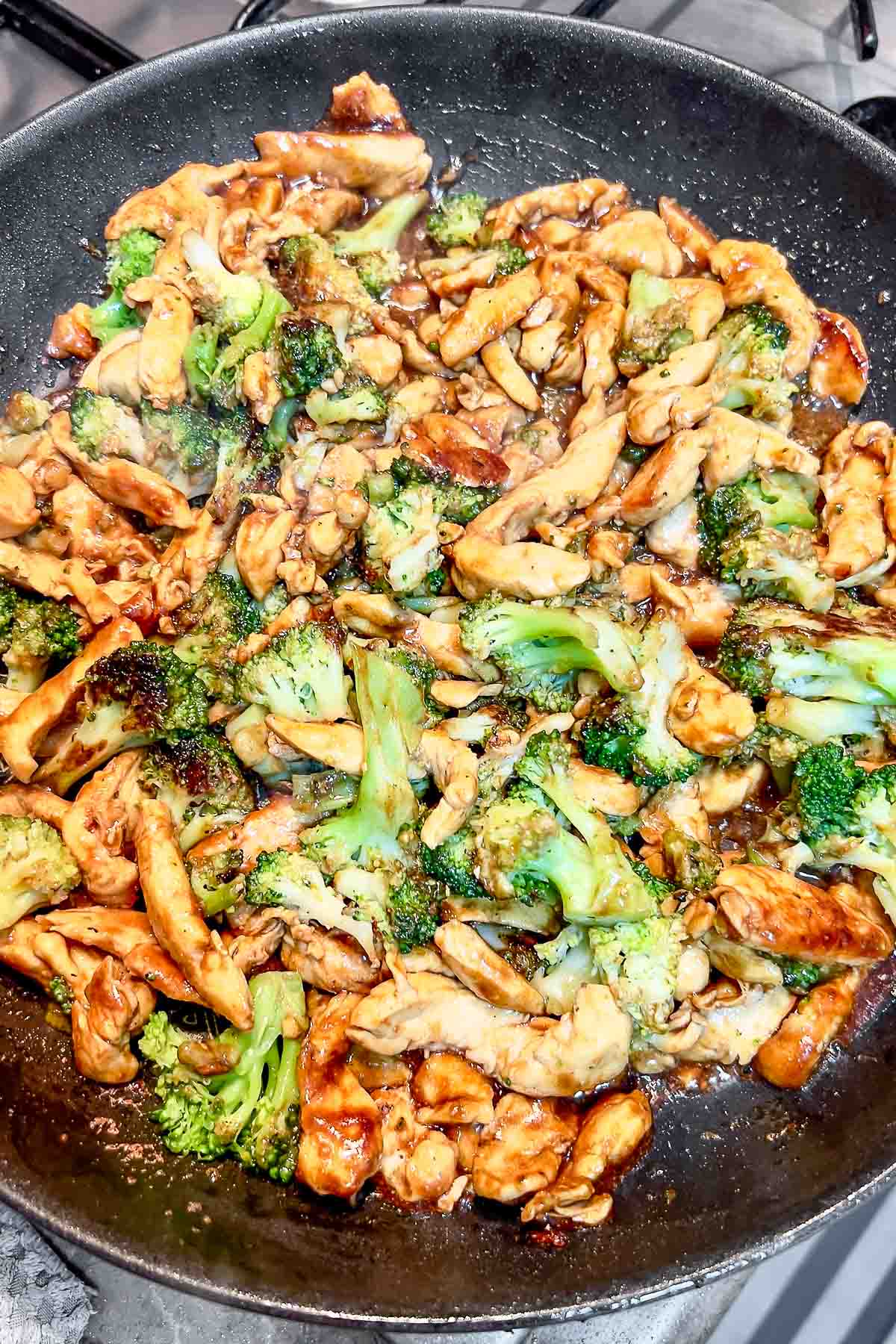 Chicken and broccoli stir fry in a pan.