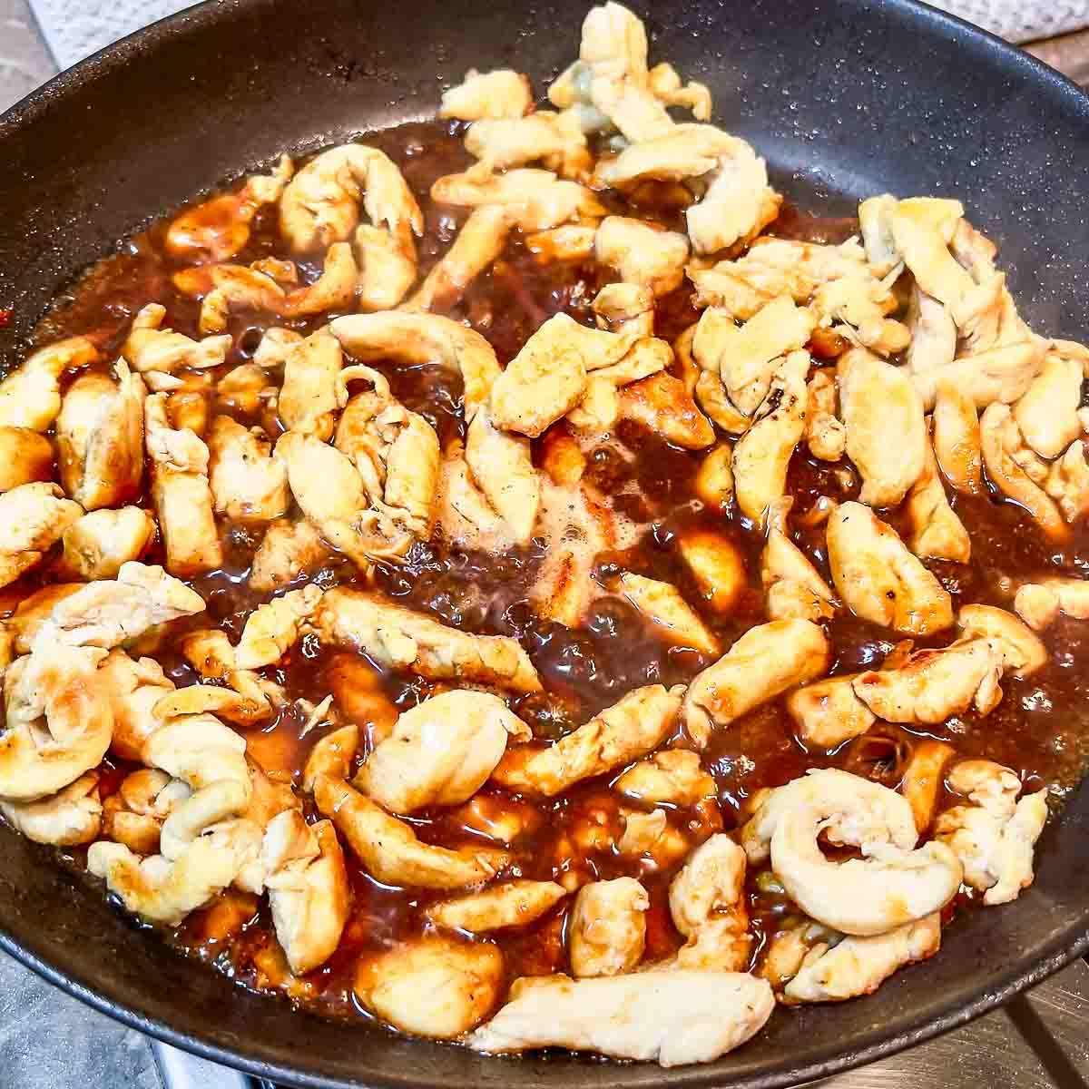 Cooked chicken and soy sauce in the pan.
