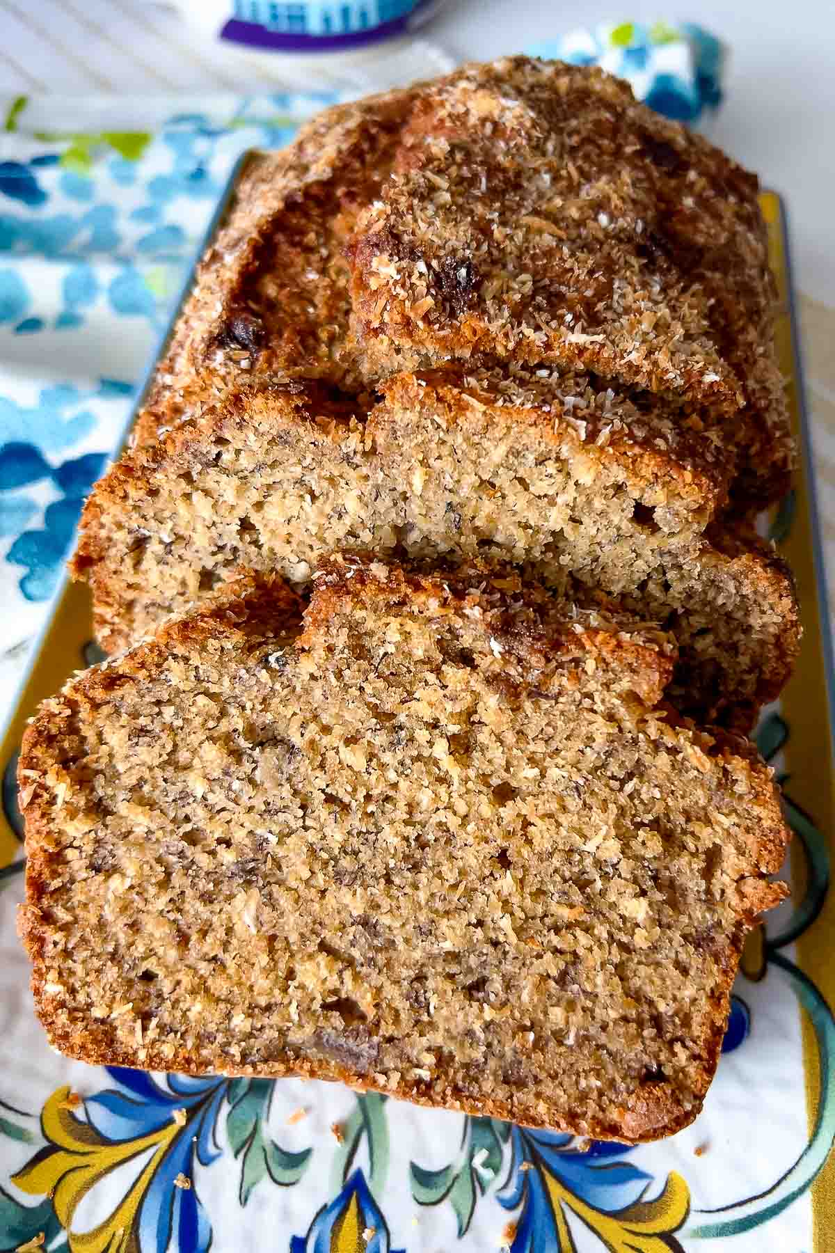 Banana Coconut Bread on a white blue and yellow platter.