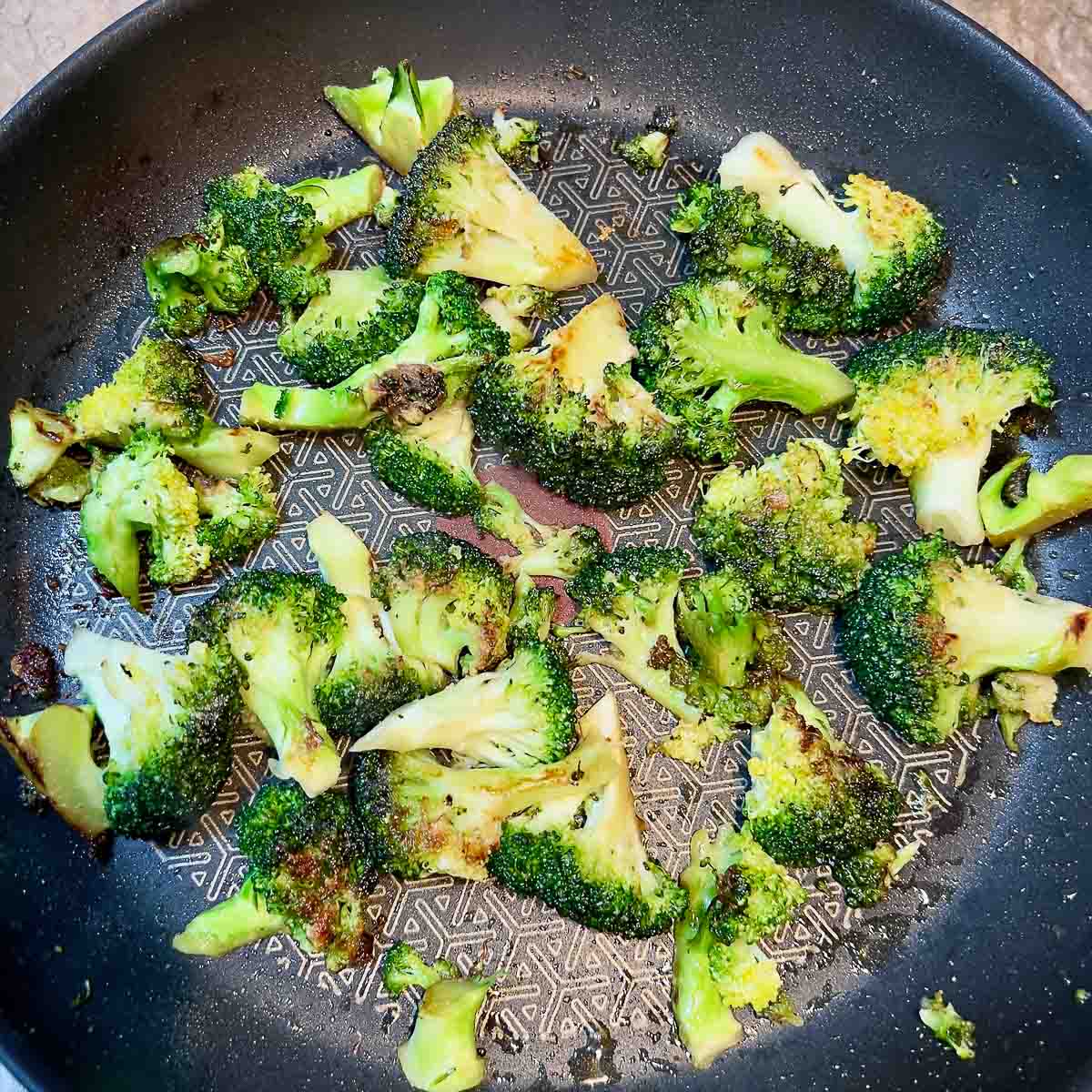 Cooking broccoli in a pan.