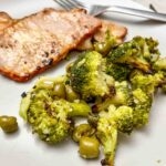 Lomo adobado served with roasted broccoli and olives.