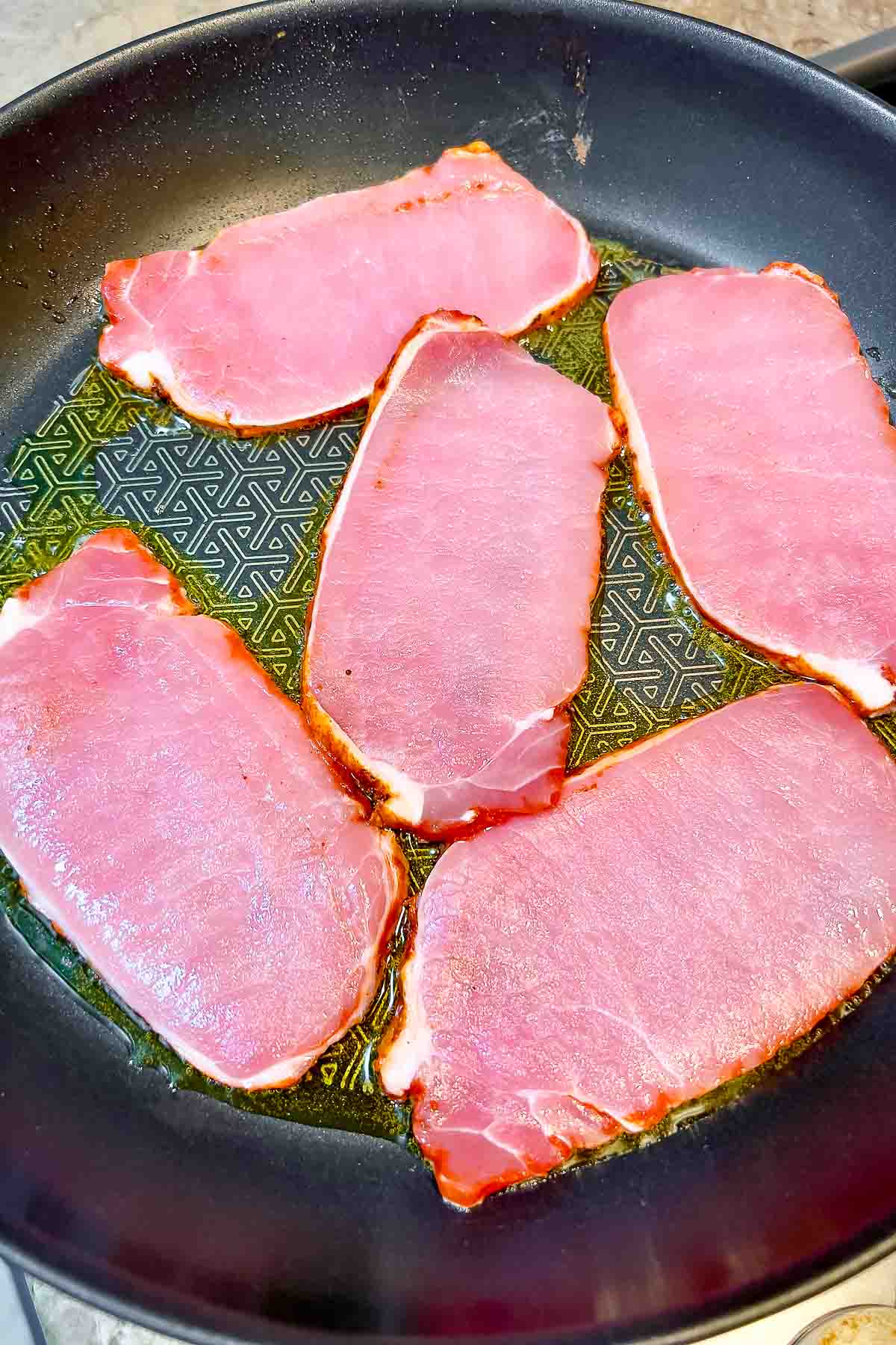 Pork Loin slices in adobo cooking in the pan.