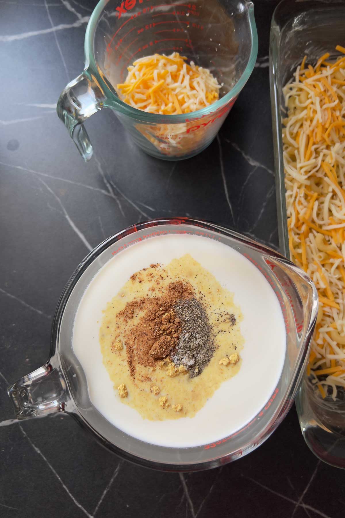 Adding spices to the milk.