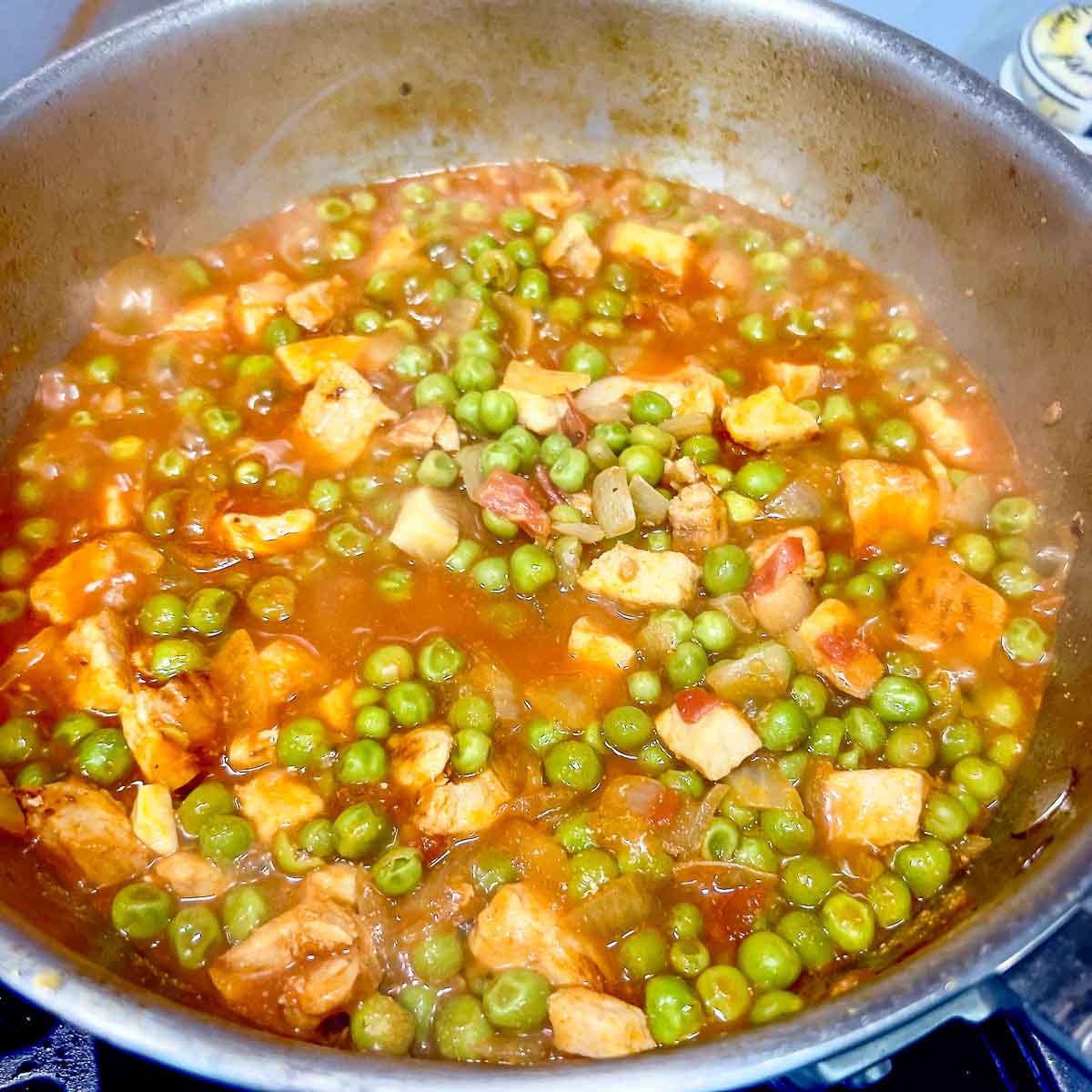 Adding water to the stew.