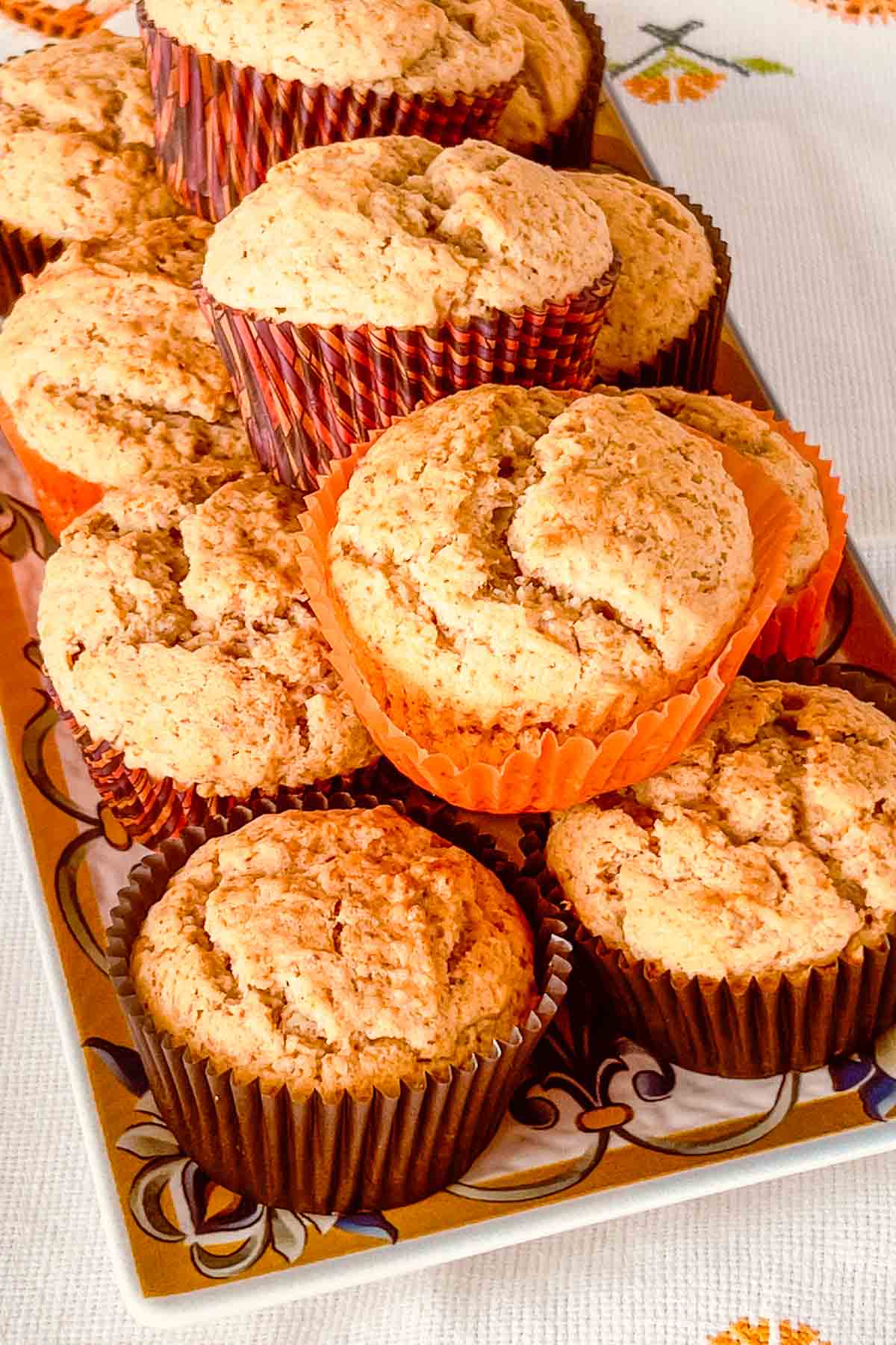 Applesauce muffins stacked on a platter.