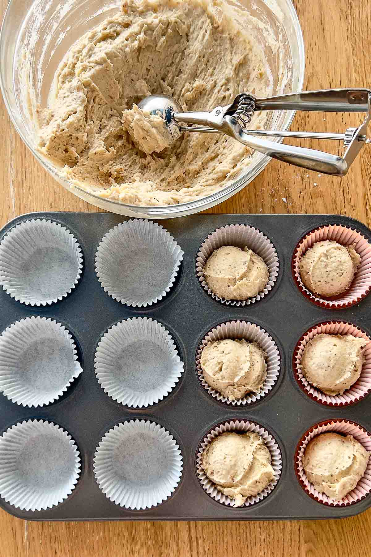 Filling the muffin pan with batter.
