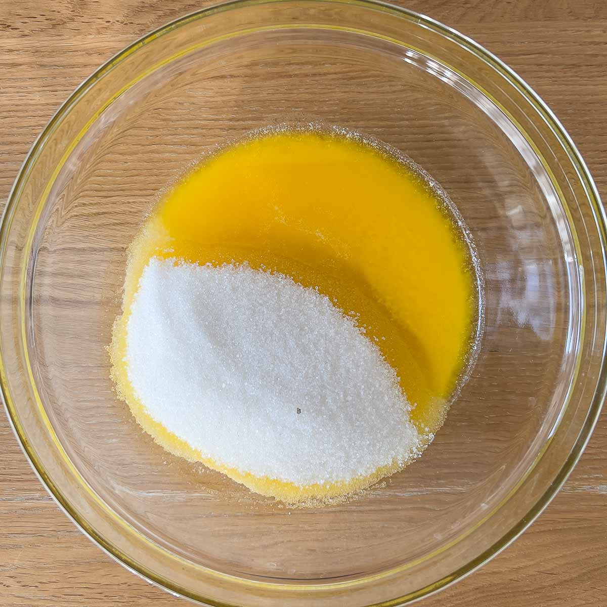 Melted butter and sugar in a bowl.