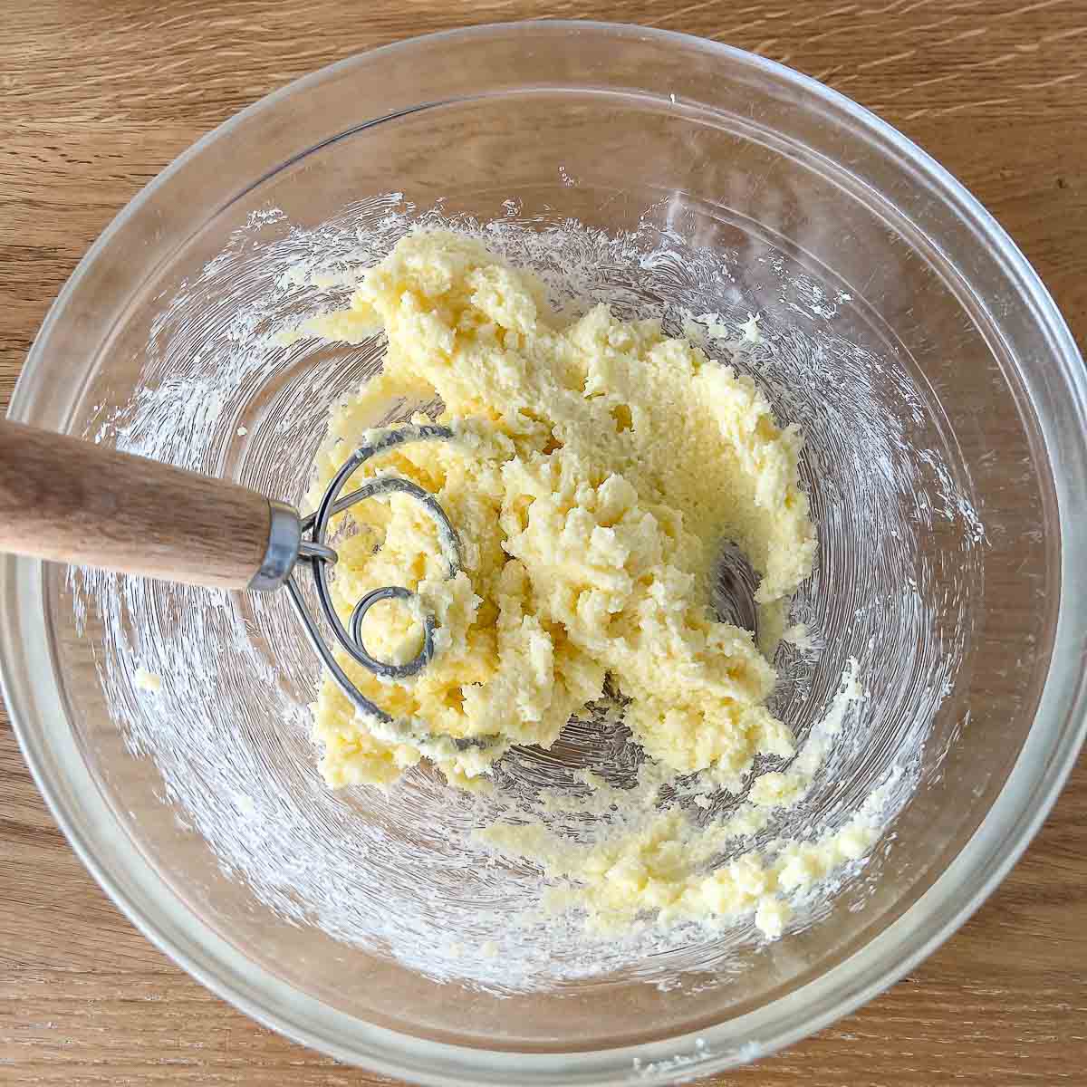 Mixed butter and sugar in a bowl.