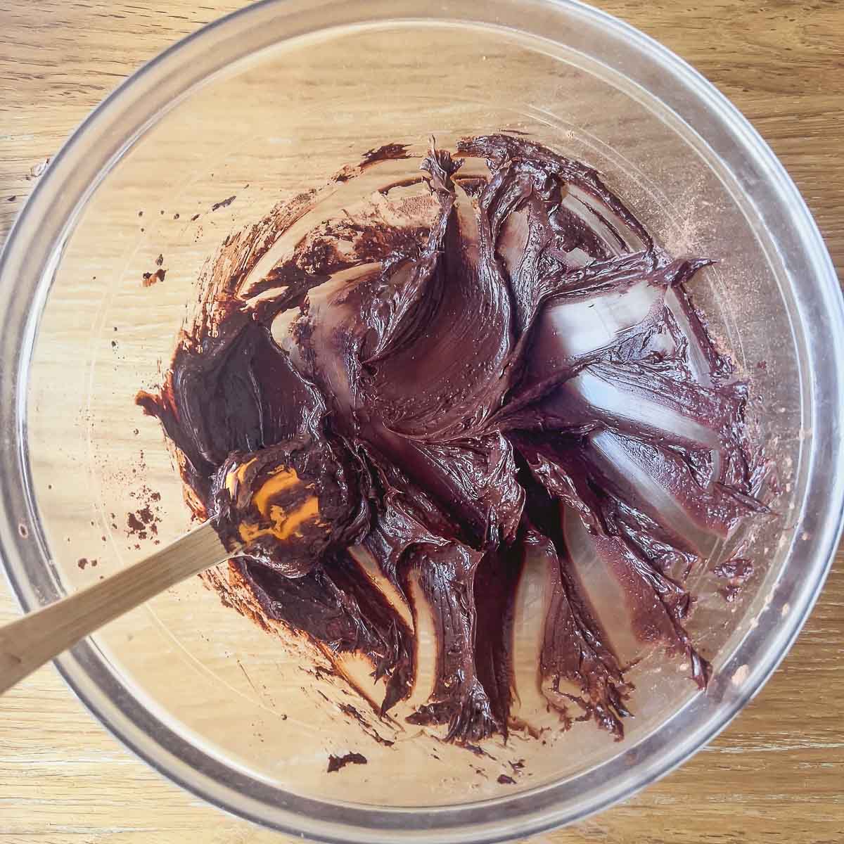 Mixing butter with cocoa powder.